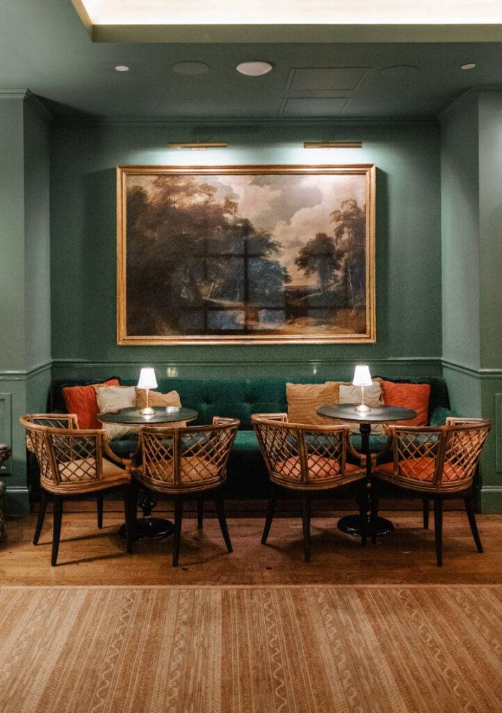 Intimate lounge vignette with woven textures, layered lighting, and a collected, residential feel that invites guests to settle in