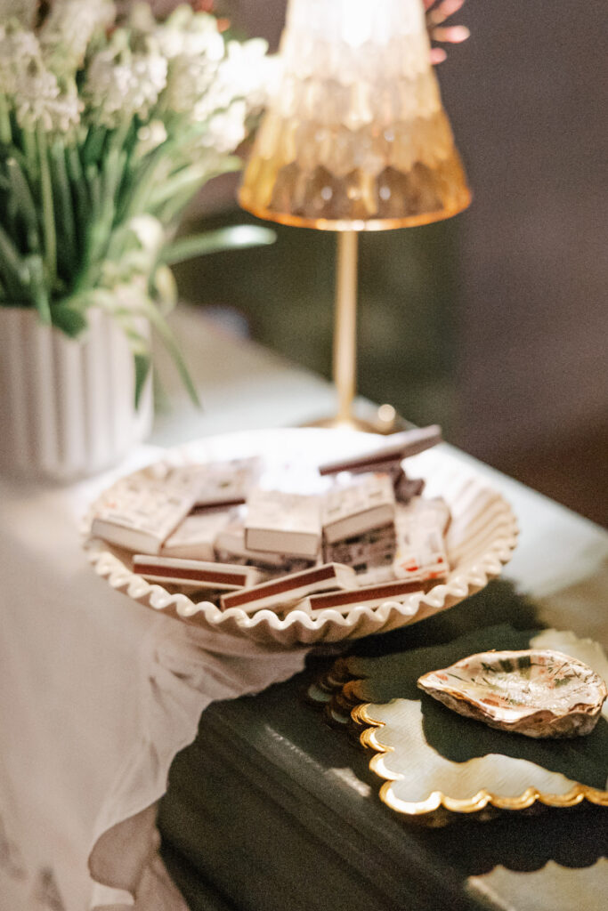 Assorted chocolate treats displayed in a scalloped dish for wedding dessert table detail, styled by New England wedding planner